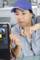mature female unscrewing a pc