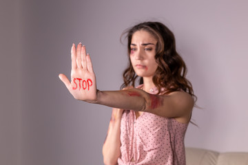 Domestic violence, protesting and people concept - brunette woman expressing denial with STOP on...