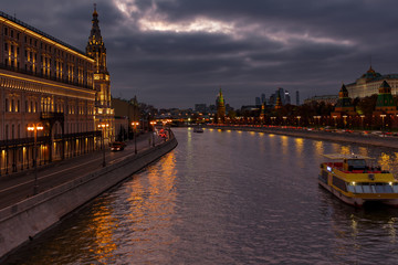 Fototapeta na wymiar Moskva river embankments on a background of dramatic cloudy sky in evening. Moscow landscape