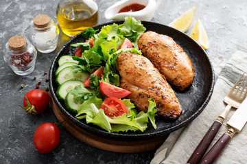 Grilled chicken breast. Fried chicken fillet and fresh vegetable salad .