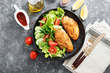 Grilled chicken breast. Fried chicken fillet and fresh vegetable salad .