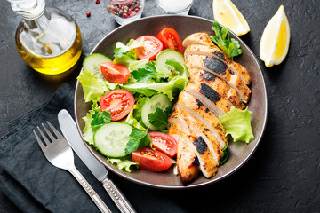 Grilled chicken breast. Fried chicken fillet and fresh vegetable salad .