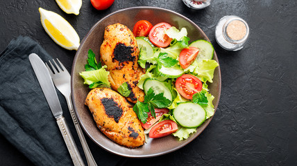 Grilled chicken breast. Fried chicken fillet and fresh vegetable salad .