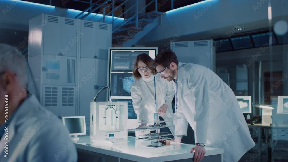 Poster Diverse International Team of Industrial Scientists and Engineers Wearing White Coats Working on Heavy Machinery Design in Research Laboratory. Professionals Using 3D Printer, Computers and Microscope