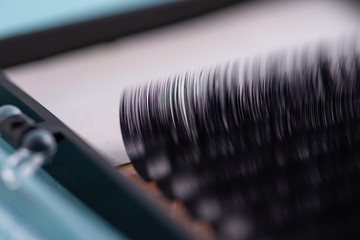 False eyelashes in pack, close up, on turquoise background