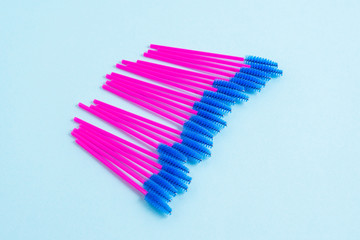 Disposable pink brushes for eyelashes and eyebrows. Close-up.