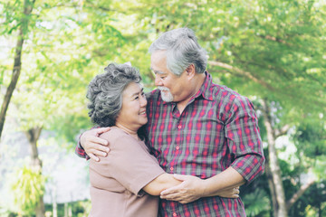 Fototapeta premium Happy love Elderly couple , Senior couple old man and senior woman relaxing hug in a forest