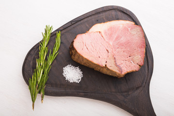 Food, meat and delicious concept - Close up of horse meat with salt on a cutting board