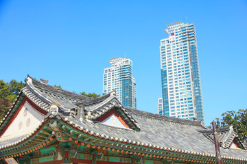 Fototapeta na wymiar Boneungsa Temple with Modern Skyline in Background, Seoul, South Korea