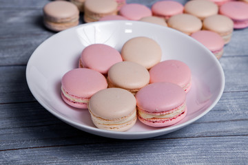 Macaron cookies in white bowl Sweet and colorful french macaroons Close up colorful macarons dessert with vintage pastel tones