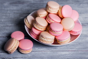 Macaron cookies in white bowl Sweet and colorful french macaroons Close up colorful macarons dessert with vintage pastel tones