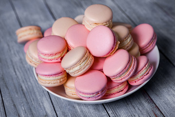 Close up colorful macarons dessert with vintage pastel tones French colorful macarons background, close up macaron or macaroons cookie, tasty dessert. food background