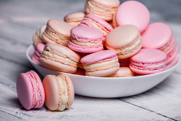 Close up colorful macarons dessert with vintage pastel tones French colorful macarons background, close up macaron or macaroons cookie, tasty dessert. food background