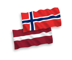 Fototapeta premium National vector fabric wave flags of Latvia and Norway isolated on white background. 1 to 2 proportion.