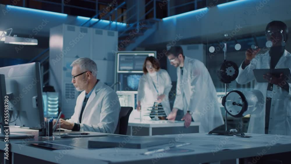 Poster moving shot in technology research laboratory, specialist uses microscope,designer works on personal