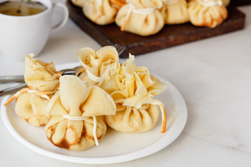 Pancakes stuffed with a bag on a white plate with meat filling