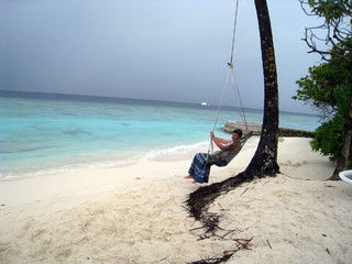 Fototapeta premium woman on swing on tropical beach