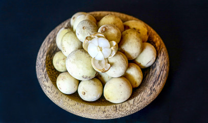 Ripe lanzones (Lansium domesticum) on black background.