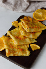 Traditional French crepes Suzette with orange sauce on white plate