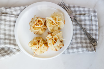 Pancakes stuffed with a bag on a white plate with meat filling
