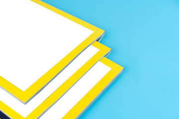 Stack magazines on blue background.