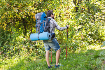 Adventures, summer tourism and nature concept - tourist arriving to a camping with his cat