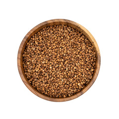 Raw buckwheat in a wooden plate isolated on white background