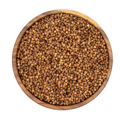 Raw buckwheat in a wooden plate isolated on white background