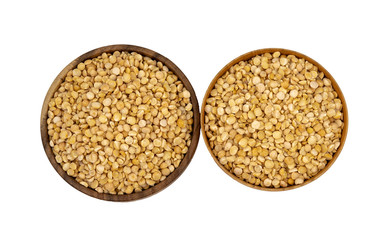 Raw yellow split peas in a wooden plate (bowl) isolated on white background, top down view