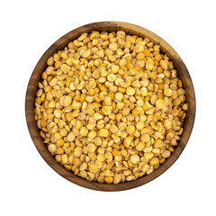 Raw yellow split peas in a wooden plate (bowl) isolated on white background, top down view