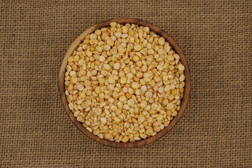 Raw yellow split plate on a burlap texture background