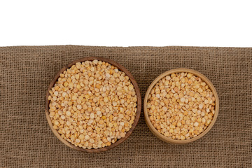 Raw yellow split plate on a burlap texture background