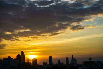 Fototapeta na wymiar Sunrise sky silhouette city building