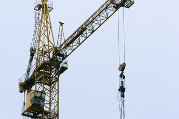 Naklejka premium Large construction cranes working on a building complex. Space for text.