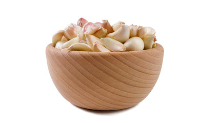 garlic cloves in wooden bowl isolated on white background. Spices and food ingredients.