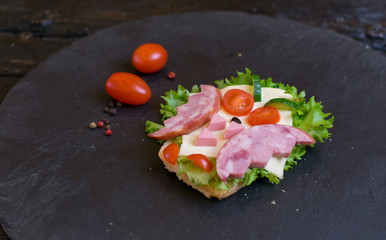 A ham sandwich made in the shape of an owl. Option of children's serving