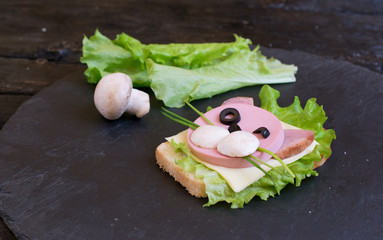 Children's sandwich with sausage made in the form of a cat. Option of children's serving