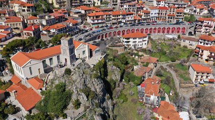 Aerial drone photo from famous and picturesque village of Arachova built on the slope of Parnassus mountain with traditional character at spring, Voiotia, Greece