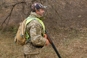 Hunters with a german drathaar and spaniel, pigeon hunting with dogs in reflective vests	