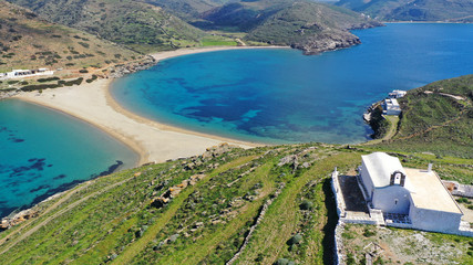 Aerial drone photo of picturesque chapel of Agios Loukas and iconic two sided sandy tropical turquoise sea paradise beach of Kolones and Fykiada in island of Kythnos at spring, Cyclades, Greece © aerial-drone