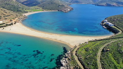 Aerial drone photo of picturesque chapel of Agios Loukas and iconic two sided sandy tropical...