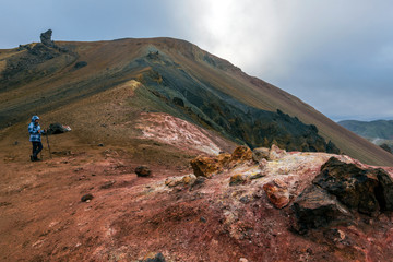 Girl in staying in the slope of Brennisteinsalda volcano mountain  in Highlands of Iceland.