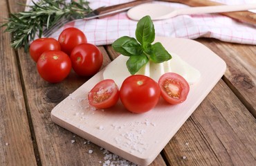 tomato mozzarella - fresh tomatoes with mozzarella cheese and basil  on a rustic wooden table - healthy breakfast