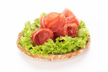 Sandwich with salami sausage on white background.