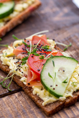 Sandwiches with cream cheese, vegetables and salami.