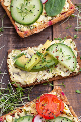 Sandwiches with cream cheese, vegetables and salami.