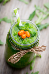 Rucola smoothie, on the grey  background.