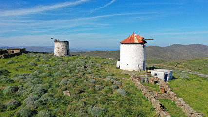 Fototapeta na wymiar Aerial drone spring photo of picturesque windmill in island of Kythnos overlooking the Aegean sea, Cyclades, Greece