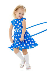 The little girl turns the hoop.