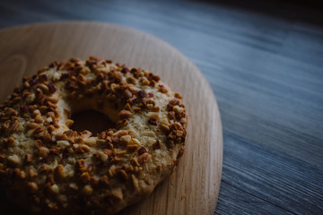Whole grain cereal shortbread biscuits cookies stacked with nuts. Wooden background